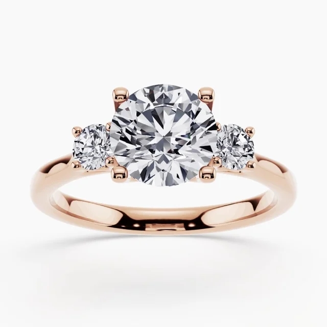 Side-stone engagement ring with accent diamonds on a white gold band