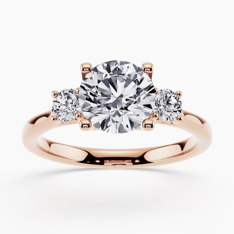 Side-stone engagement ring with accent diamonds on a white gold band